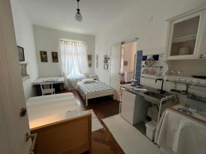 a kitchen with a sink and a living room at Guest House Ilicki Plac in Zagreb