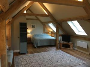 a bedroom with a bed in a attic with skylights at Impstone House B & B in Bower Chalke