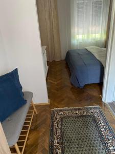 a room with a bed and a rug in a room at Apartments & Room - Korzo in Sombor