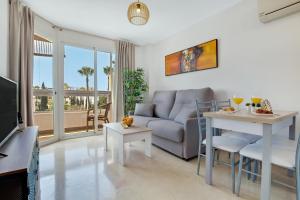 a living room with a couch and a table at Vistamarina A309 By IVI Real Estate in Torremolinos