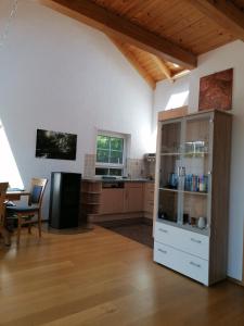 a kitchen with a large white cabinet and a table at Weinstrassenblick in Burrweiler