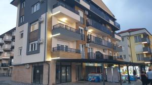 a tall building with people standing in front of it at APARTMAN 5 BMB in Veliko Gradište