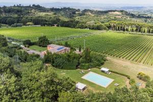 an aerial view of a estate with a swimming pool and a vineyard at Villa Boschetto in Montepulciano