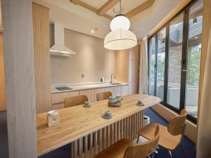 a kitchen and dining room with a wooden table and chairs at UH Suite Seoul Square in Seoul