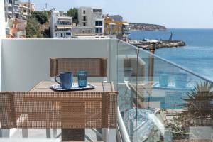 a balcony with a table with a coffee cup on it at Serenita apartments 2 in Agios Nikolaos