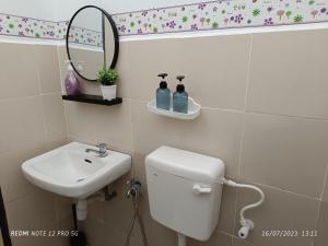 ガンバンにあるAras G Homestayのバスルーム(トイレ、洗面台、鏡付)