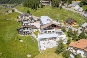 an aerial view of a large house on a hill at Hotel Cevedale in Solda