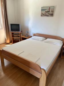 Postel nebo postele na pokoji v ubytování Apartments Antunović