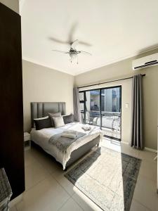 a bedroom with a bed and a large window at Meridian Suite Apartments in Umhlanga Ridge in Durban +80 photos