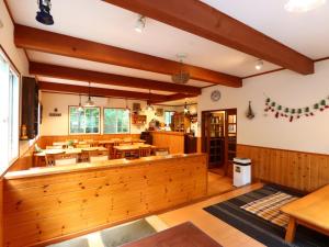 a dining room with tables and chairs in it at Pension Alps Hakuba in Hakuba