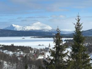 a view of a snow covered mountain and a lake at Tärnaby UpHill in Tärnaby