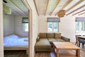 a room with a couch and a bed and a table at Apartamenty Białe Brzozy in Florczaki +189 photos