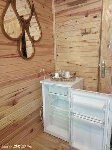 a bathroom with wooden walls and a vanity with a mirror at MJORA Bungalov Ayder in Güroluk