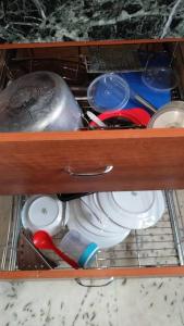 a drawer with plates and other items in it at Luxurious 3 BHK Flat in Ghaziabad in Ghaziabad