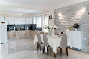 a kitchen and dining room with a table and chairs at Artemis Villas in Gardíkion