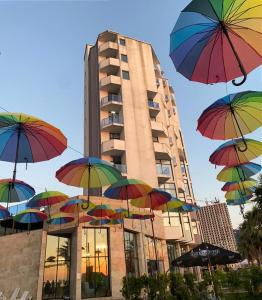 a group of umbrellas in front of a building at Pano Hotel in Gonio
