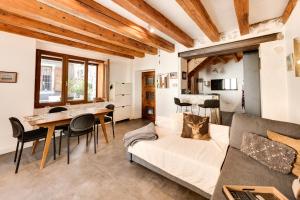 a living room with a couch and a table at La Terrasse du vieil Annecy in Annecy