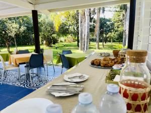 a table with a plate of food and water bottles at Borgo Camicia In in Barcellona-Pozzo di Gotto