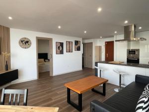 a living room and kitchen with a table and a couch at Luxury Views Marbella in Marbella