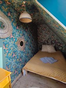 a small bed in a room with a wall at Maison de campagne à 2h de Paris in Droué