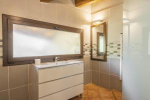 a bathroom with a sink and a mirror at Mossen Batista Faig in Les Iglésies