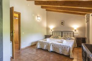Cama o camas de una habitación en Mossen Batista Faig