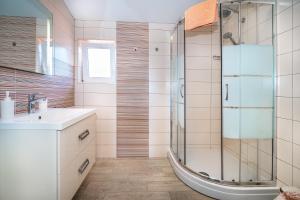 a bathroom with a shower and a sink at Apartments Kricin 14 Laura in Baška +29 photos