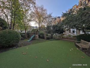 a backyard with a playground with a slide at The GG Spot in South Kensington Central London 2 Bedroom Apartment by Wild Boutique Apartments in London