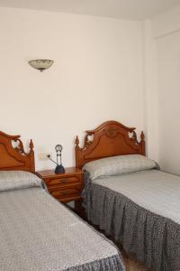 um quarto com duas camas e um candeeiro sobre uma mesa em Apartamento vacacional Jávea em Xàbia