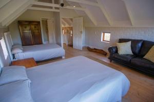 a living room with a bed and a couch at Valley Farm Stay in Knysna
