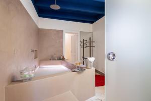 a bathroom with a bath tub with a blue ceiling at Palazzo Sant'Agostino in Palermo +99 photos