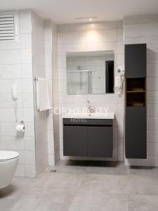 ein Badezimmer mit einem Waschbecken, einem WC und einem Spiegel in der Unterkunft Formercity Termal Hotel in Eskisehir