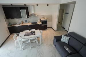 a kitchen and living room with a table and a couch at La Casa di Sossy in Civitanova Marche +9 photos
