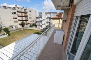 a balcony with a trash can and some buildings at La Casa di Sossy in Civitanova Marche