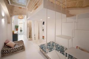 a living room with white walls and glass shelves at WePuglia - Dimora Elia in Polignano a Mare