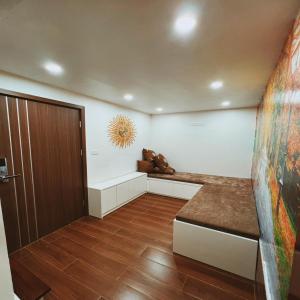 a room with a hallway with a door and wooden floors at Cua Bac Modern Home in Central Hanoi in Hanoi