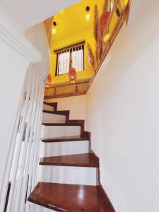 a staircase in a house with a yellow ceiling at Cua Bac Modern Home in Central Hanoi in Hanoi
