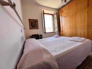 a bedroom with a bed with two towels on it at Vicolo Dell'Oro in Siena