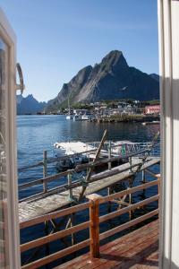 a view of a dock with boats in the water at Authentic central located cabin close to Reinebringen Lofoten in Reine