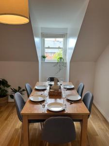 uma sala de jantar com uma mesa de madeira e cadeiras em Homely 2 Story Cathedral City Apartment em Durham