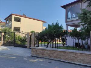 a fence in front of a house at Polynikis Apartment in Nikiti