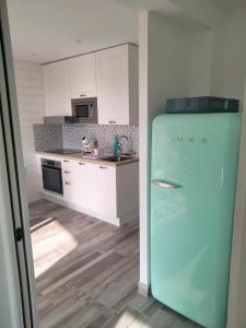 - une cuisine avec un réfrigérateur bleu dans la chambre dans l'établissement Ambeille Collioure, à Collioure
