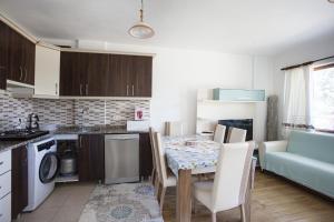 a kitchen with a table and a dining room at House w Balcony and Garden 1 min to Beach in Datca in Datca