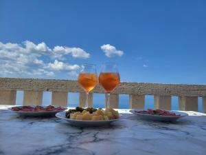 a table with a plate of food and two glasses of wine at Apartment Andjela in Starigrad