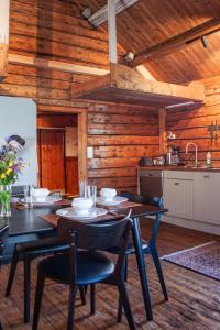 a dining room with a table and chairs in a kitchen at Authentic central located cabin close to Reinebringen Lofoten in Reine
