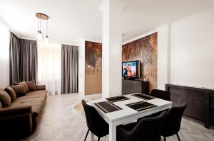 a living room with a table and a couch at VILA REYNA in Galaţi