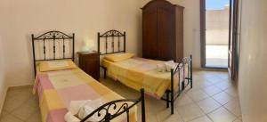 Postel nebo postele na pokoji v ubytování Villetta Maldive Salento