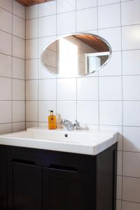 a bathroom with a sink and a mirror at Authentic central located cabin close to Reinebringen Lofoten in Reine
