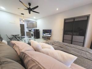 a living room with a couch and a ceiling fan at [Instastellar Experience] 3 Pax, 15 mins fr CIQ in Johor Bahru