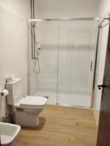 a bathroom with a shower and a toilet and a sink at Monasterio de Moraime in Muxia +32 photos
